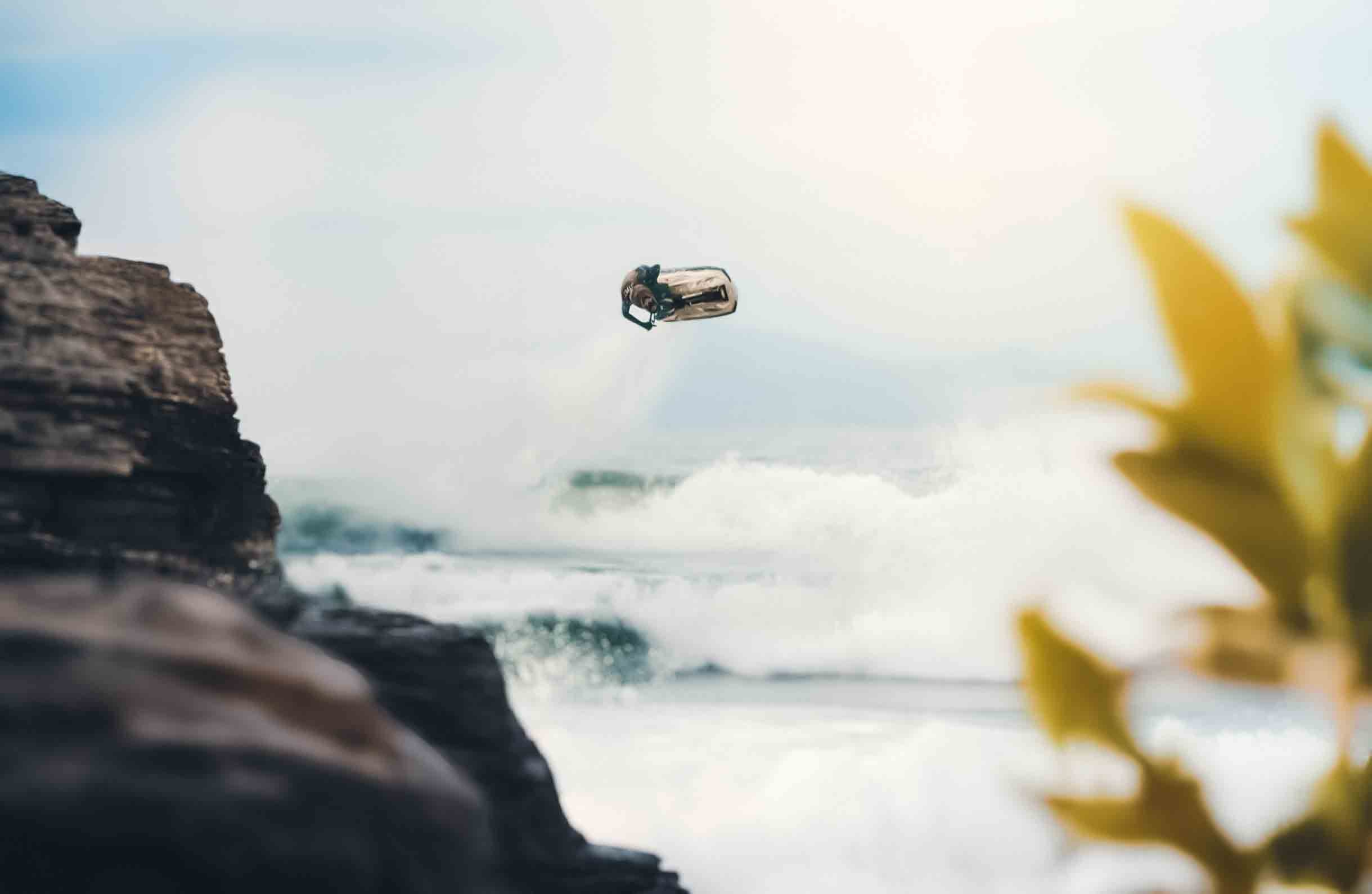 a guy jumping on a jetski